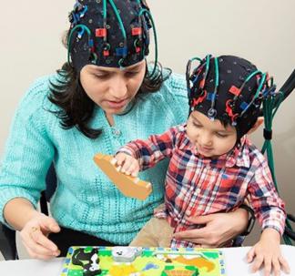 Researcher and Child with Headsets On
